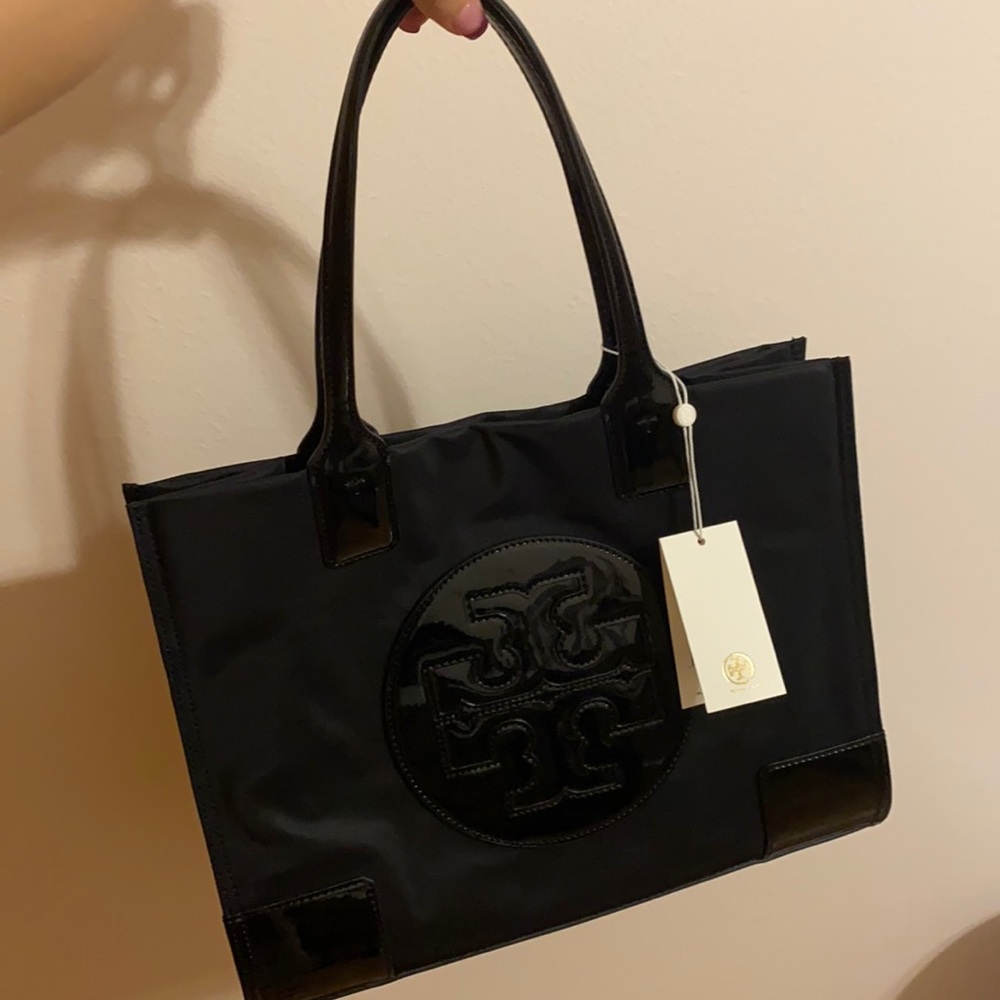 Tory Burch black bag with tags near used